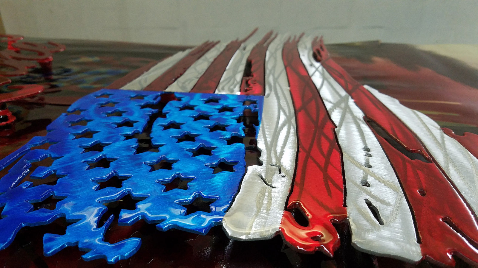 tattered and torn american flag metal art